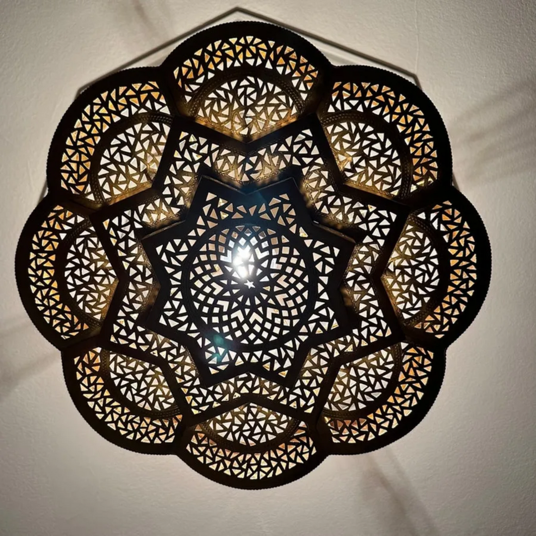 Close up of hand-carved floral brass details on pre-wired pendant fixture for high-end retail catalogs.