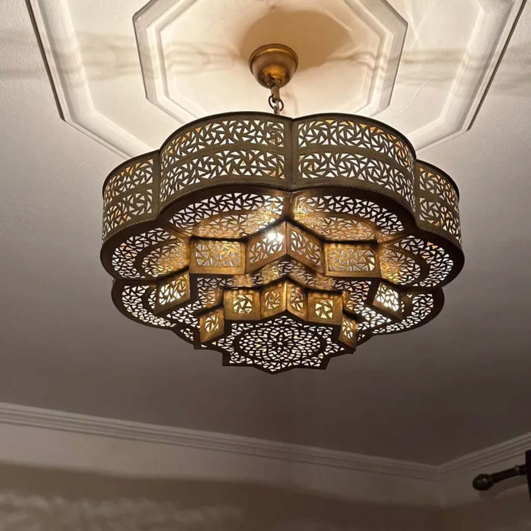 Spherical Moroccan brass pendant light in flower pattern with pre-wired assembly for commercial projects.