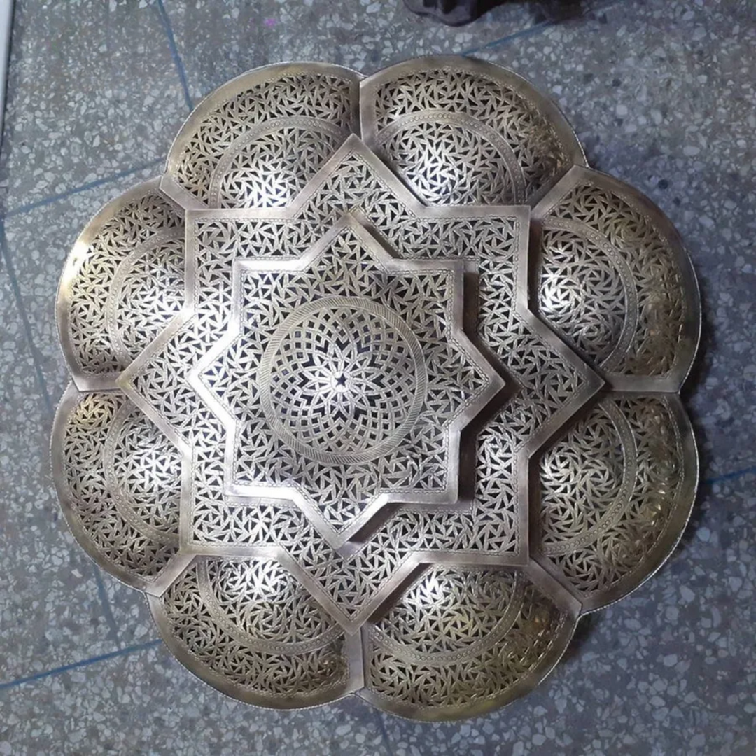 Flower pattern brass sphere hanging lamp casting warm shadow patterns, ideal for showroom display and retail sales.