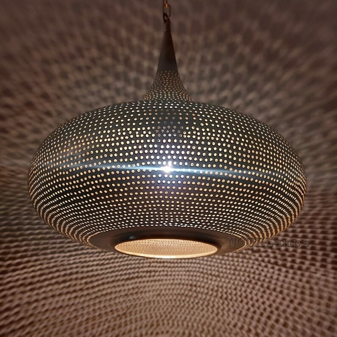 Assyl Moroccan lamp shade in brass finish casting gentle glow above tables, lounges, and quiet sitting corners.