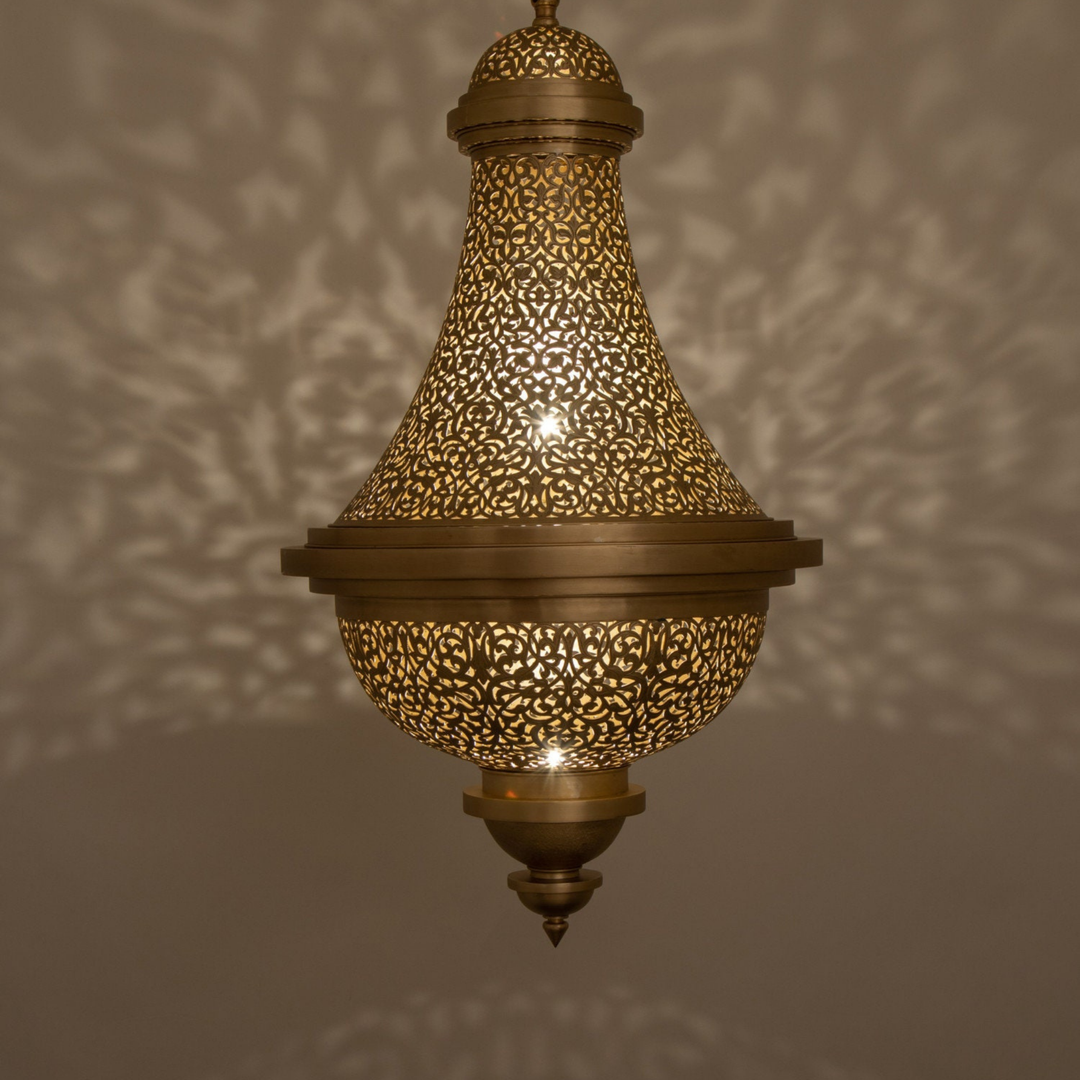 Hanan brass ceiling light with pierced dome design casting warm patterned illumination across dining rooms and bedroom ceilings.
