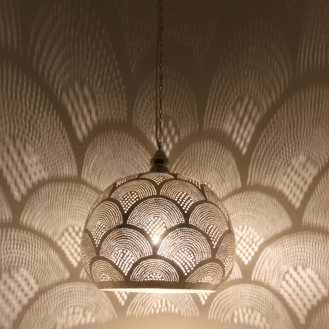 Rania brass ceiling light with dome shaped shade casting warm golden patterns across a calm bedroom ceiling.
