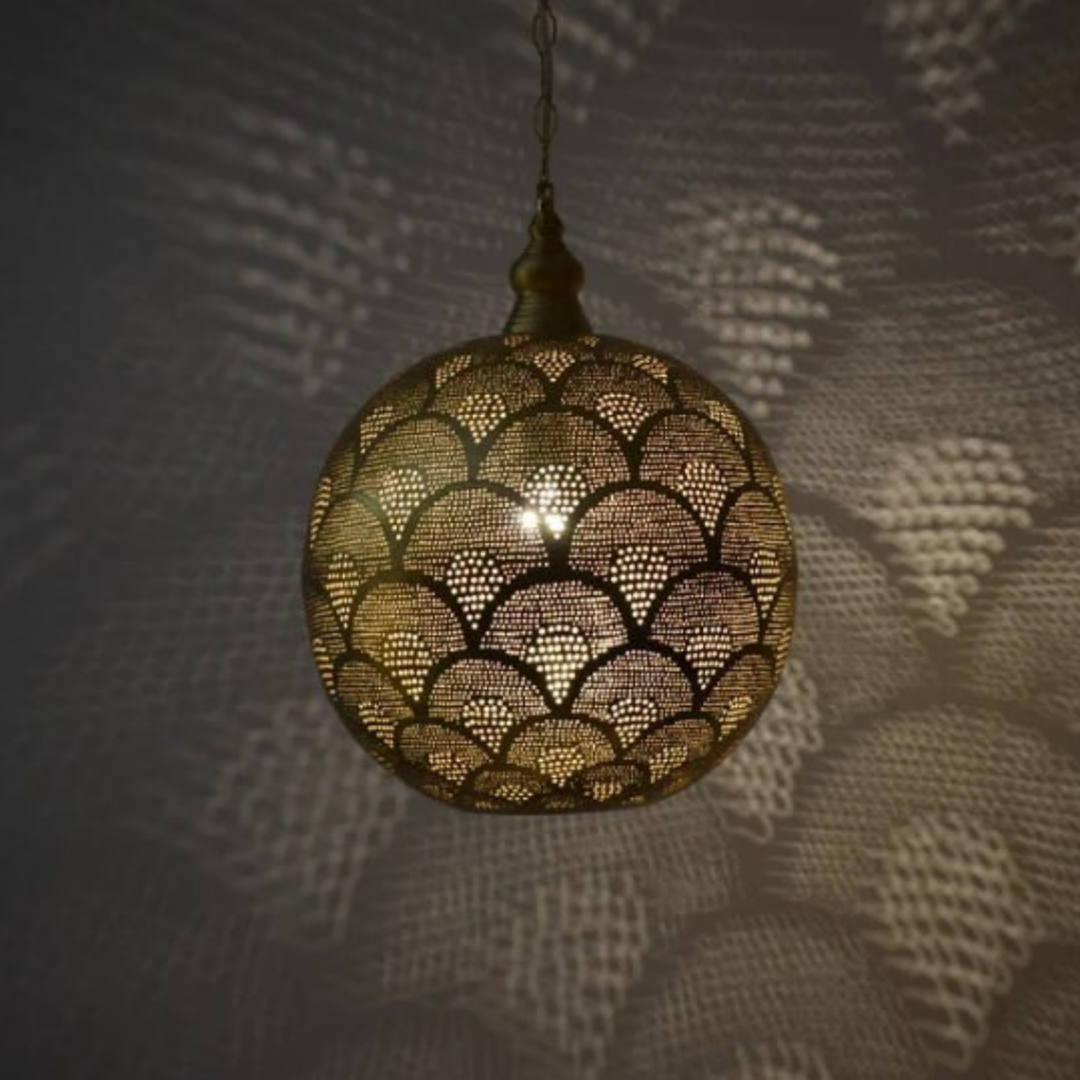 Zayne brass ceiling light with decorative metal detailing bringing warm overhead glow to dining rooms and bedroom settings.