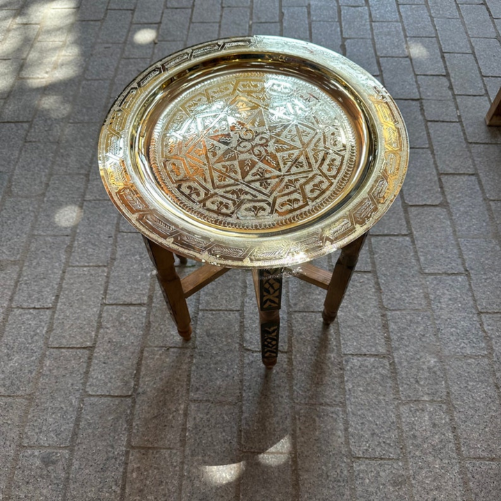 Moroccan Hand Engraved Tray Dehbi styled on a table with polished brass shine and traditional Moroccan surface pattern