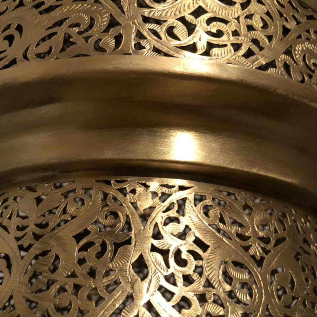 Detailed Hilal brass shade with small punched motifs, curved surface texture, and soft lantern style lighting.