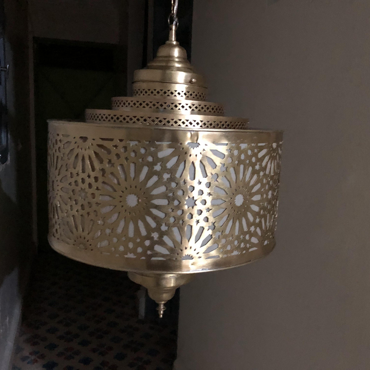 Detailed Ibrahim Parchment shade with brass trim, smooth warm surface, and soft lantern inspired lighting.