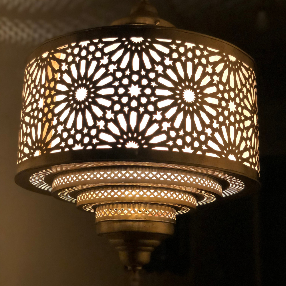 Close view of Ibrahim Parchment ceiling pendant showing brass details and smooth parchment inspired surface.