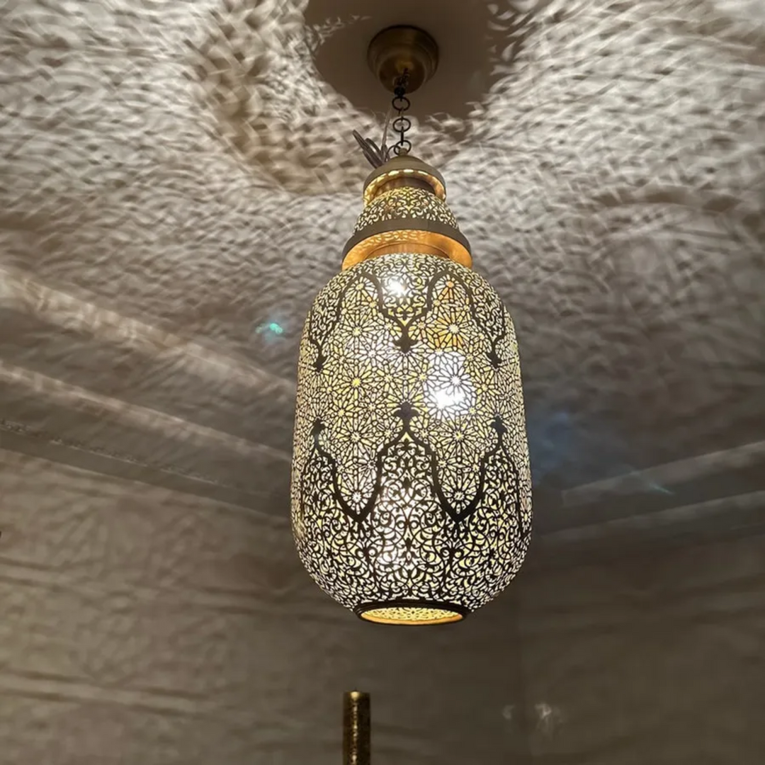 Jamila brass ceiling light with graceful pendant shape and warm golden glow for dining rooms, bedrooms, and Moroccan interiors.