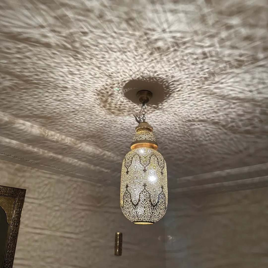 Jamila ceiling fixture with handcrafted brass detail and smooth rounded form for warm ambient light in stylish interior spaces.