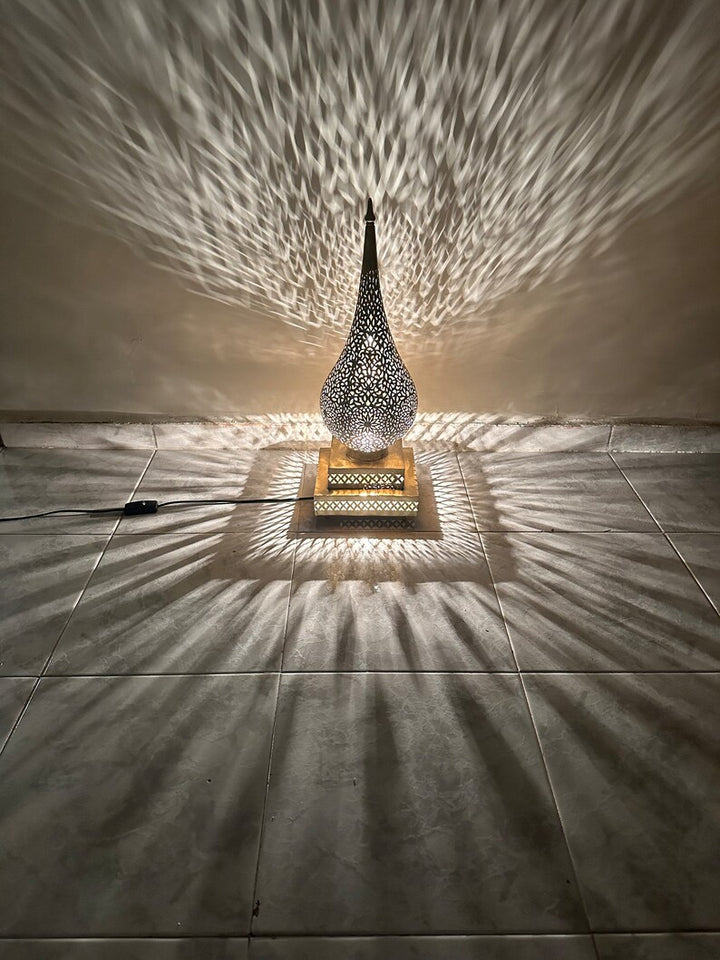 Close detail of Jawahir artisan surface work showing Moroccan pattern design on a decorative lamp.