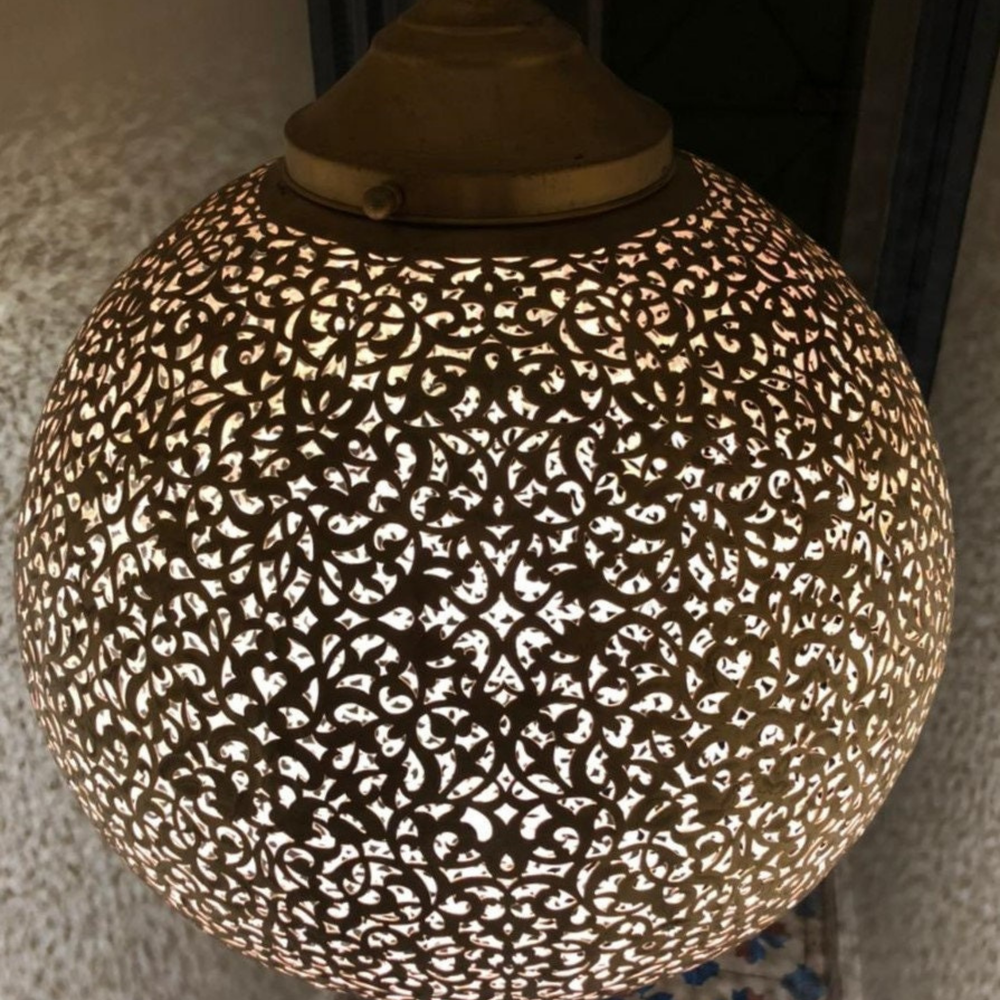 Close view of Koora Moroccan brass shade showing rounded metal form and detailed hand-punched openings.