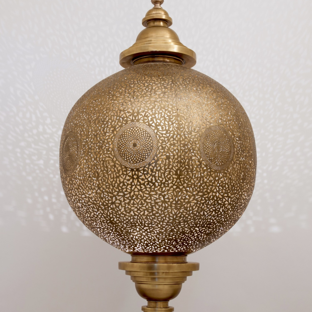 Maher brass ceiling light with balanced hanging shape and warm golden glow for dining rooms, bedrooms, and elegant interiors.