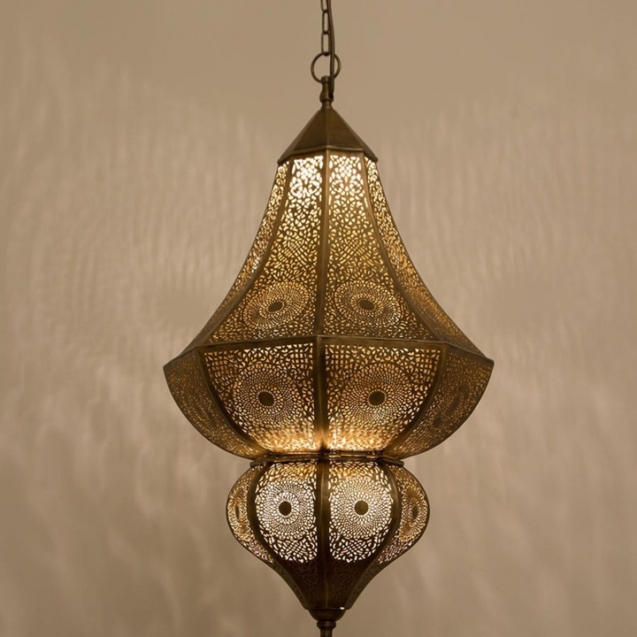 Maya brass ceiling light with handcrafted pendant form and warm golden glow for dining rooms, bedrooms, and Moroccan interiors.