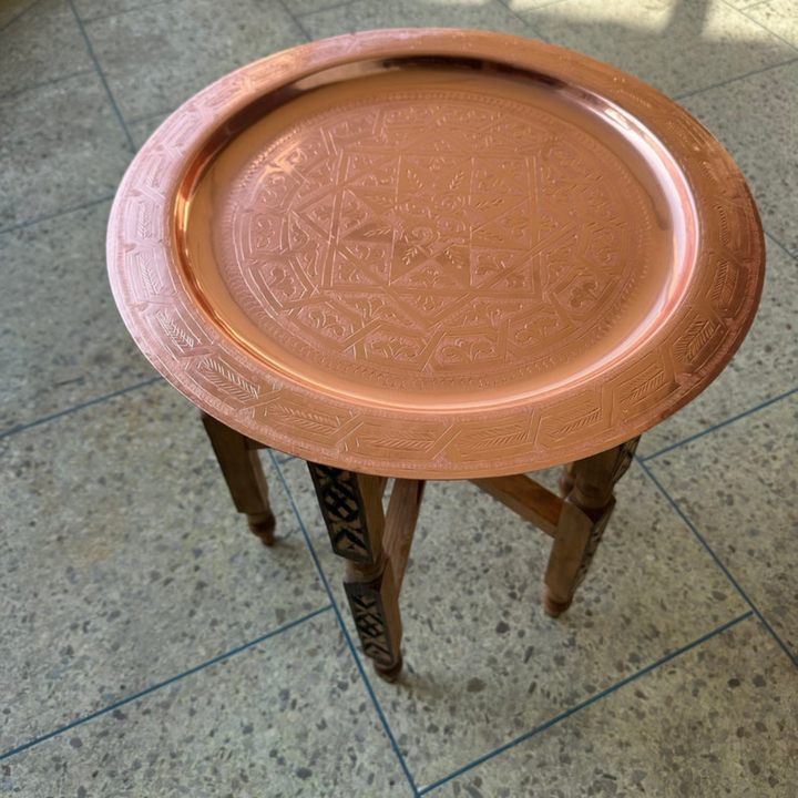 Moroccan Hand Engraved Tray Dehbi used as a centerpiece with detailed brass artwork and elegant dining presentation
