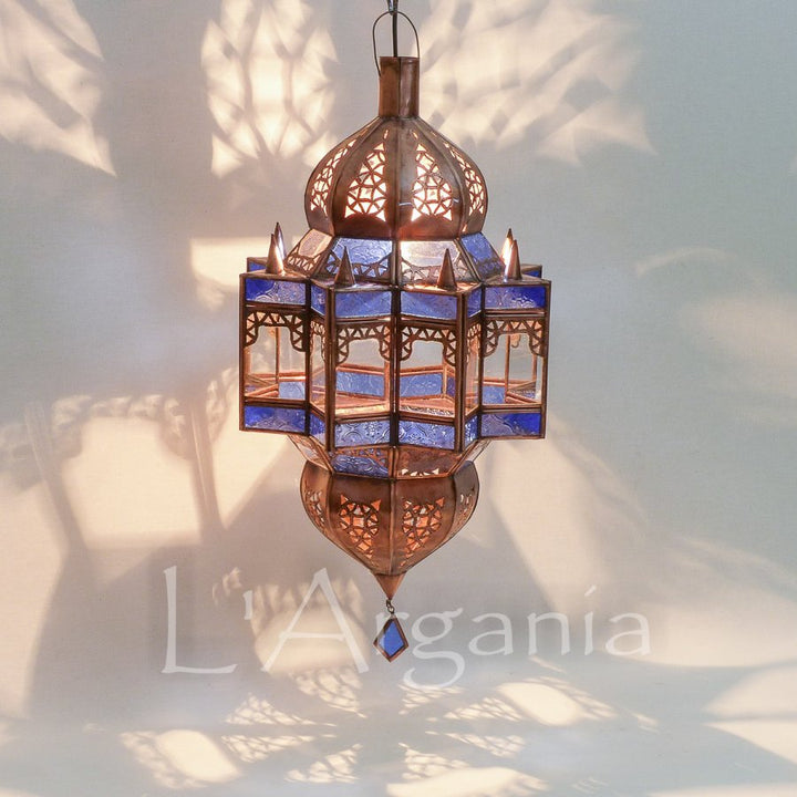 Mqenta Sky lantern with blue glass panels and handmade Moroccan metal frame for outdoor patio styling.