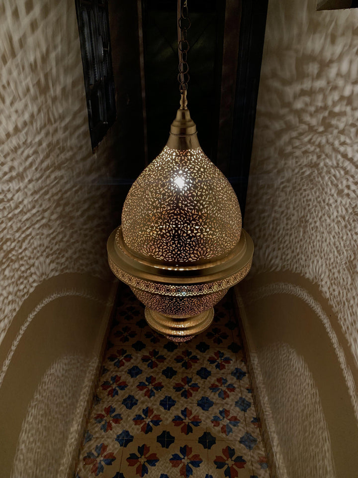 Brass Ceiling Light Nassim XL used as a room statement with large brass shade and soft decorative illumination