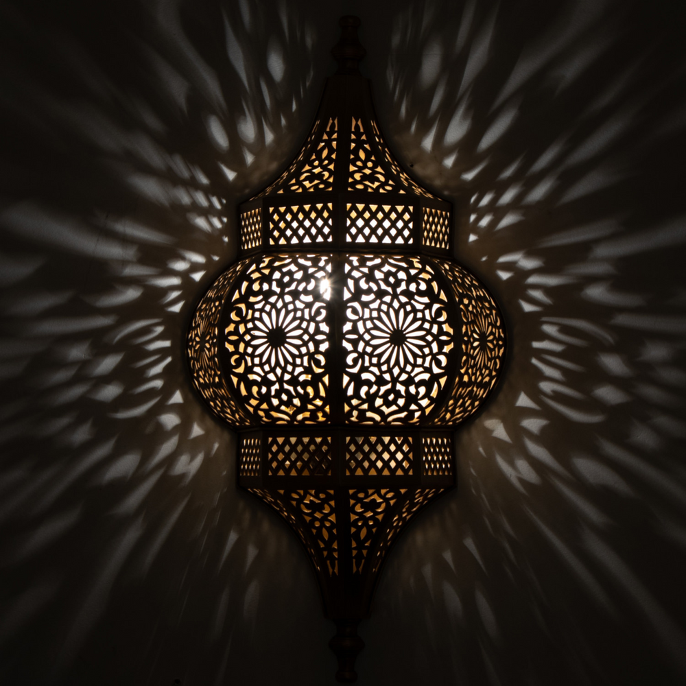 Brass Wall Sconce Raya showing Moroccan brass finish and soft illumination for entryways, lounges, and decorative walls