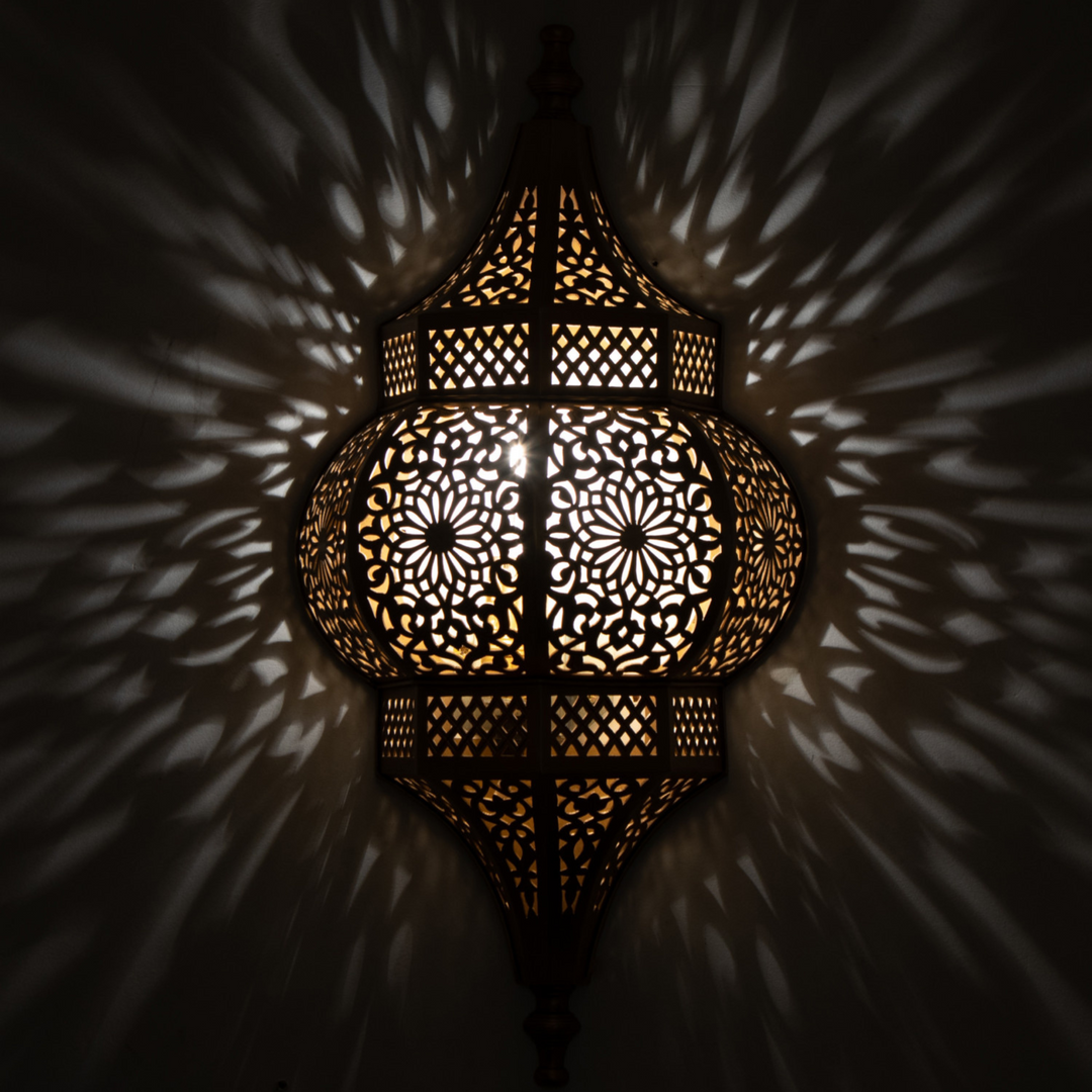 Brass Wall Sconce Raya showing Moroccan brass finish and soft illumination for entryways, lounges, and decorative walls