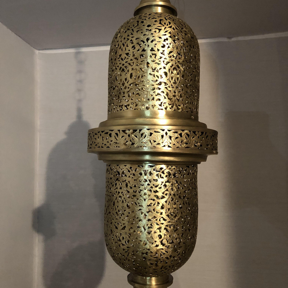 Close view of Salim Moroccan ceiling fixture showing pierced brass openings and polished handmade metal detail.